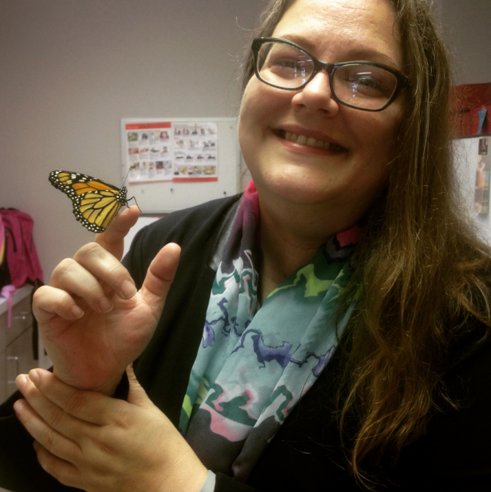 Cindy Leonard with a butterfly landed on their hand